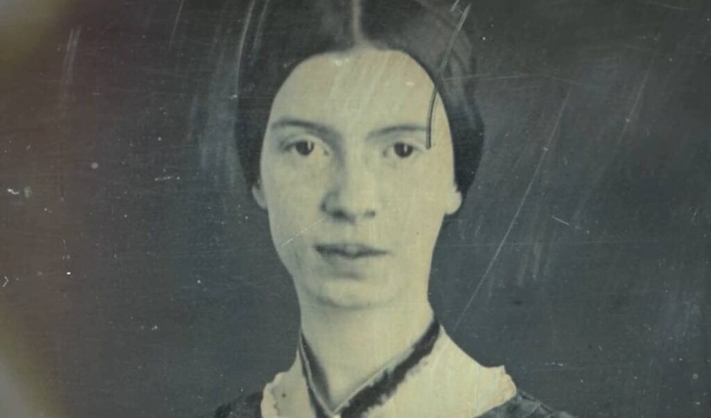 Close-up of a young woman's portrait, appearing somber, in grayscale